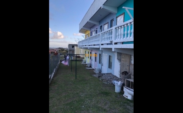 Back of property with clothes line